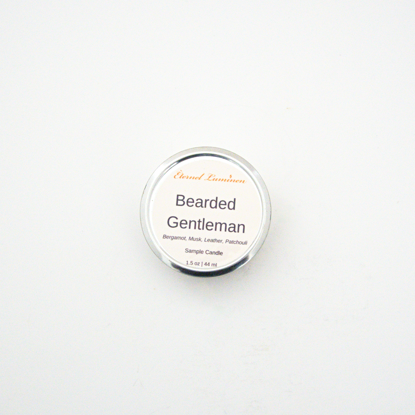 A 1.5oz Bearded Gentleman sample candle in a tin jar sitting against a white background made by Eternel Luminen