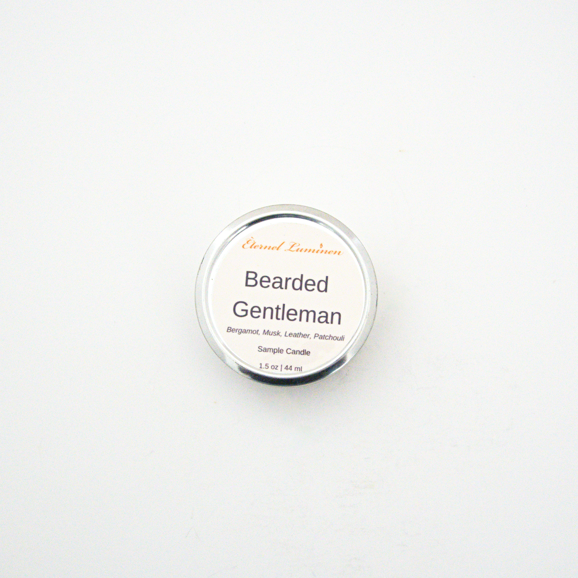 A 1.5oz Bearded Gentleman sample candle in a tin jar sitting against a white background made by Eternel Luminen