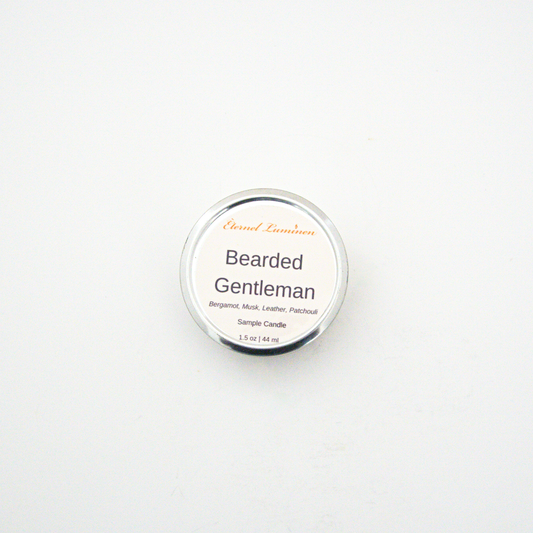 A 1.5oz Bearded Gentleman sample candle in a tin jar sitting against a white background made by Eternel Luminen