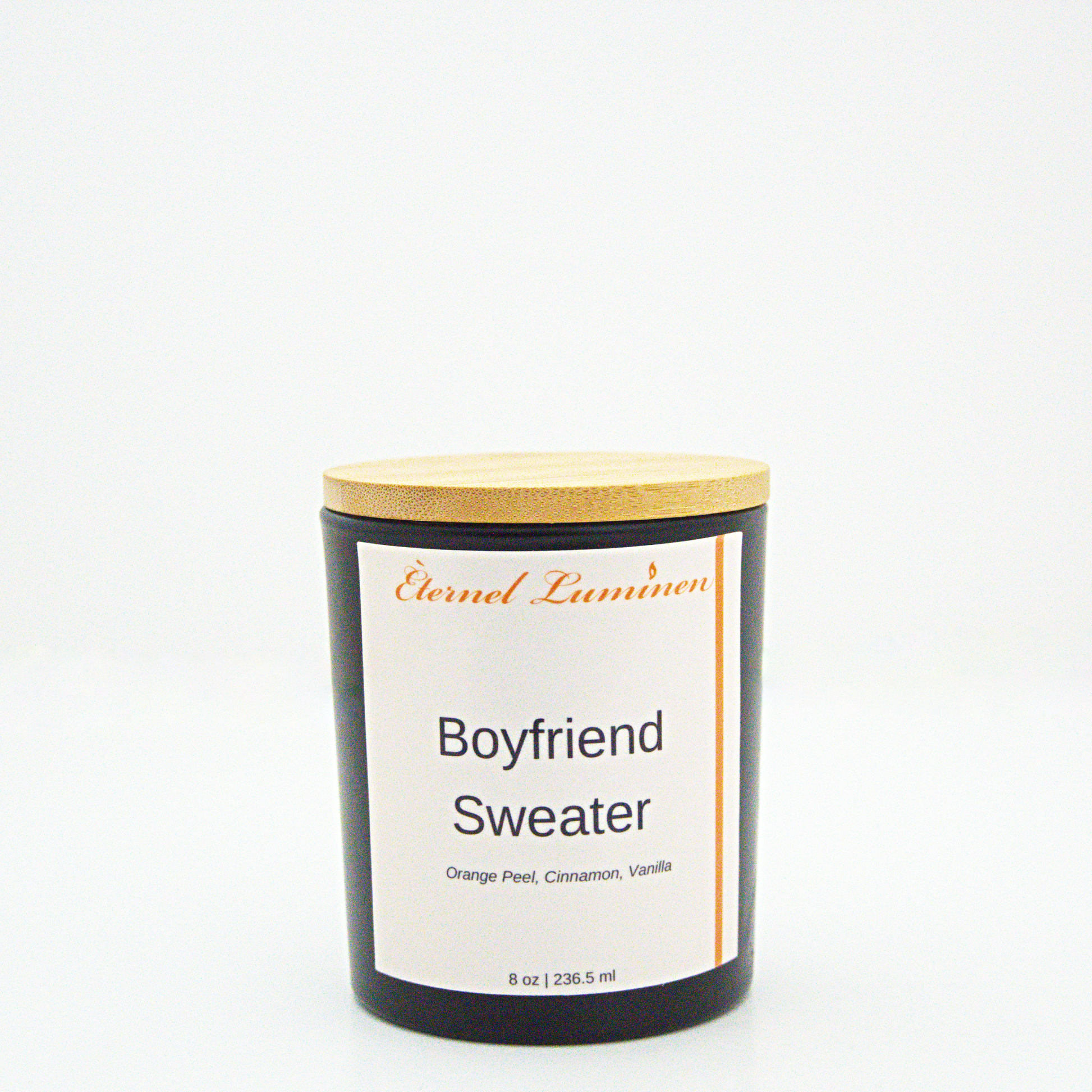 A 8 oz frosted Boyfriend Sweater candle with a wooden lid sitting against a white background made by Eternel Luminen.