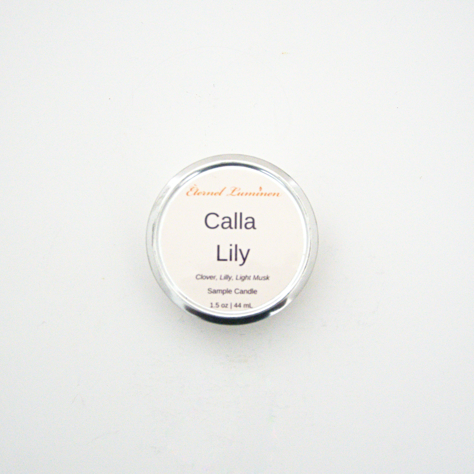 A 1.5oz Calla Lily sample candle in a tin jar sitting against a white background made by Eternel Luminen