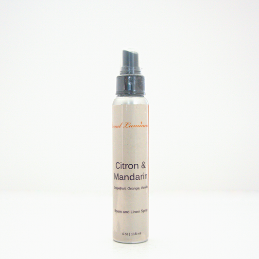 A 4oz Citron & Mandarin room & linen spray sitting against a white background made by Eternel Luminen.