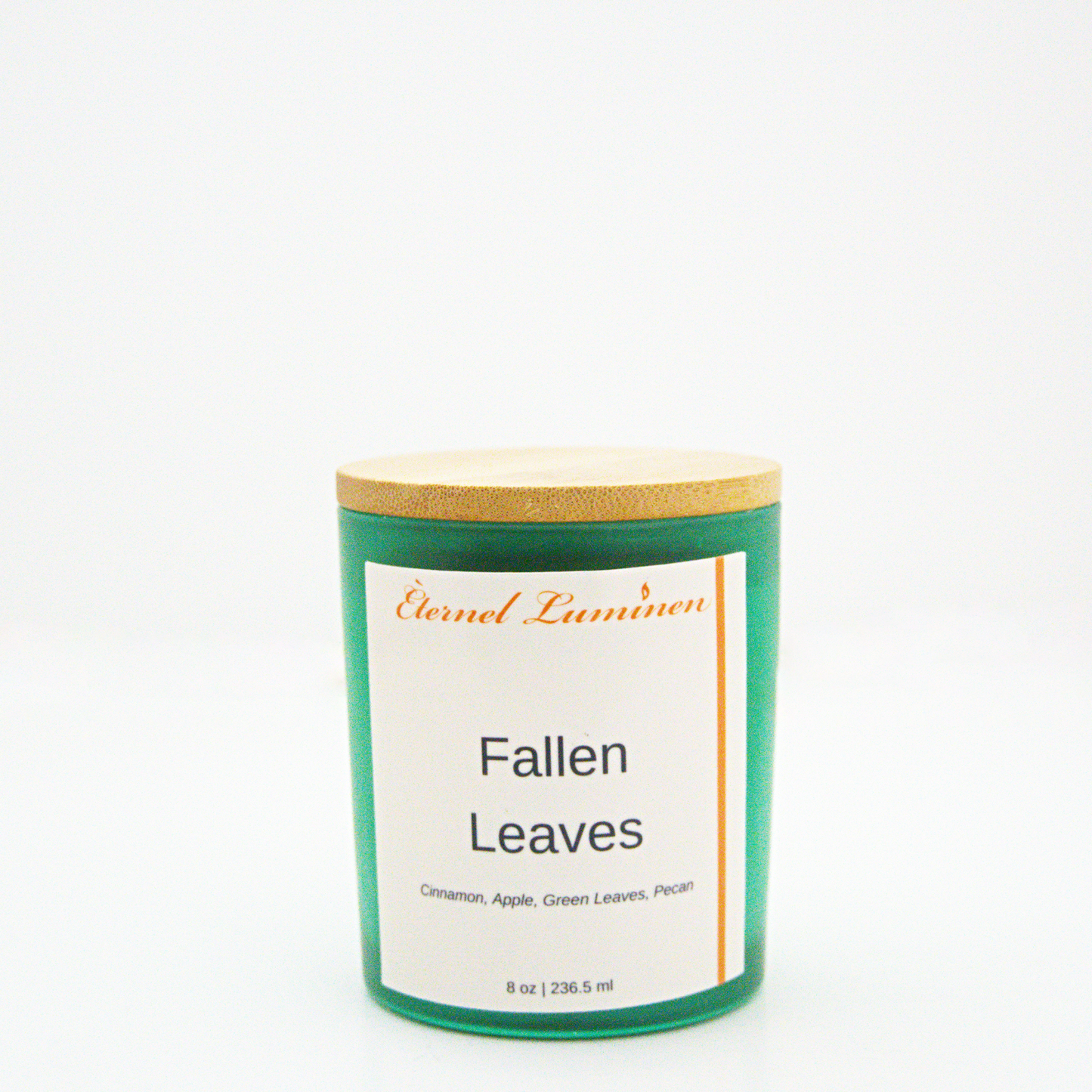 A 8 oz frosted Fallen Leaves candle with a wooden lid sitting against a white background made by Eternel Luminen.