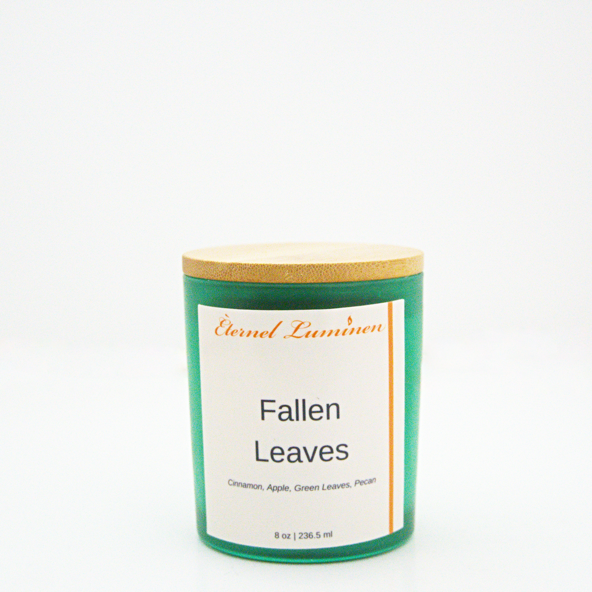 A 8 oz frosted Fallen Leaves candle with a wooden lid sitting against a white background made by Eternel Luminen.