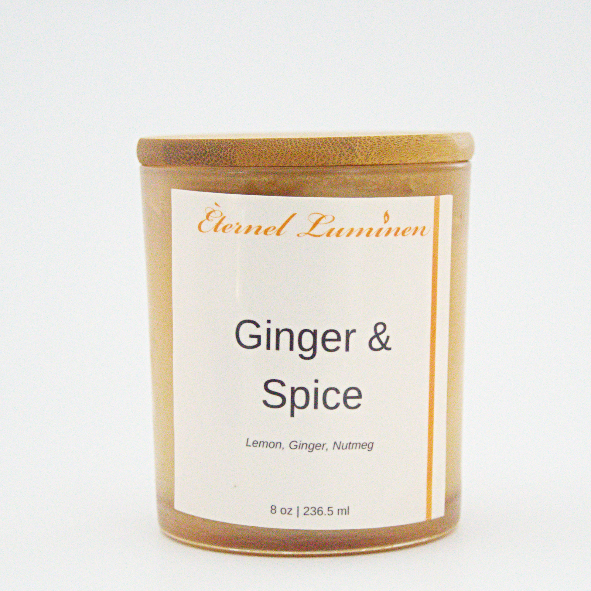 A 8 oz Ginger & Spice frosted candle with a wooden lid sitting against a white background
