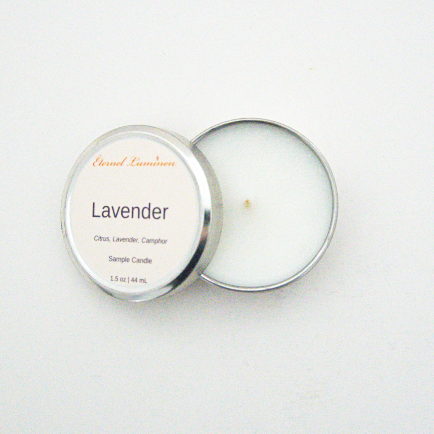 A 1.5oz Lavender sample candle in a tin jar with the lid off sitting against a white background made by Eternel Luminen.