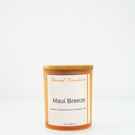 A 8 oz frosted Maui Breeze candle with a wooden lid sitting against a white background made by Eternel Luminen.