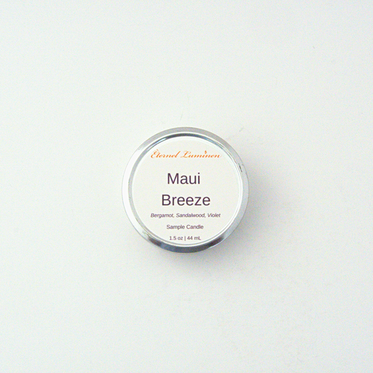 A 1.5oz Maui Breeze  sample candle in a tin jar sitting against a white background made by Eternel Luminen