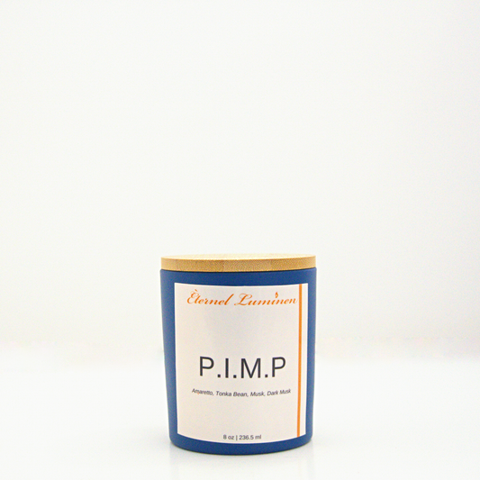 A 8 oz P.I.M.P frosted candle with a wooden lid sitting against a white background