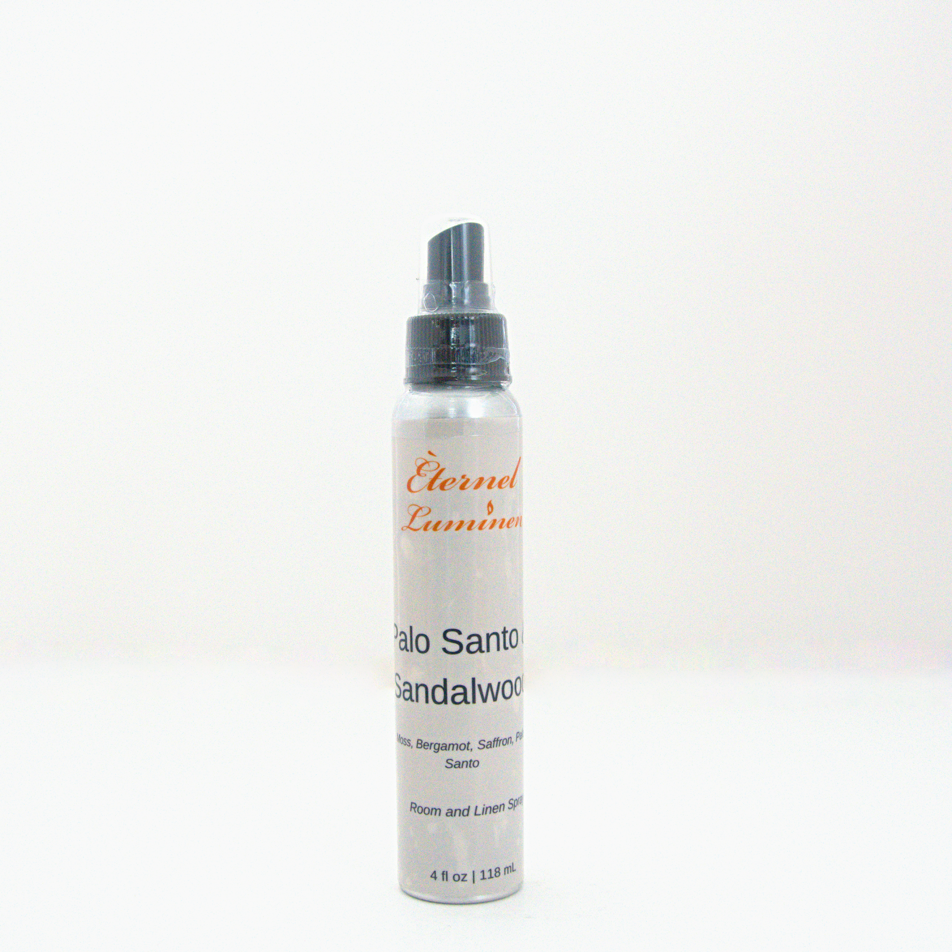 A 4oz Palo Santo & Sandalwood room & linen spray sitting against a white background made by Eternel Luminen.