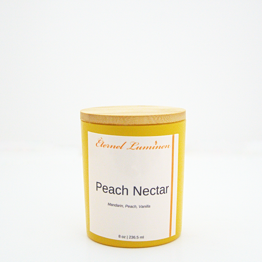 A 8 oz Peach Nectar frosted candle with a wooden lid sitting against a white background made by Eternel Luminen.