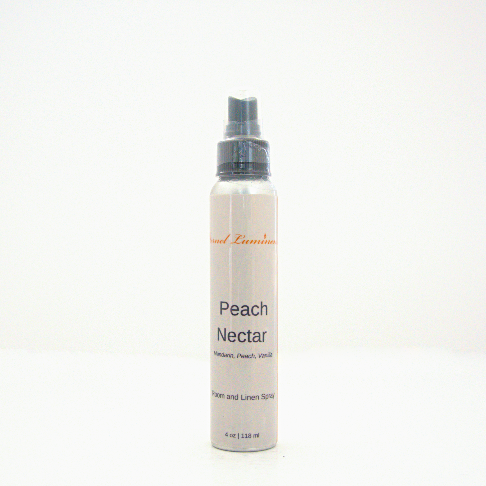 A 4oz Peach Nectar room & linen spray sitting against a white background made by Eternel Luminen.