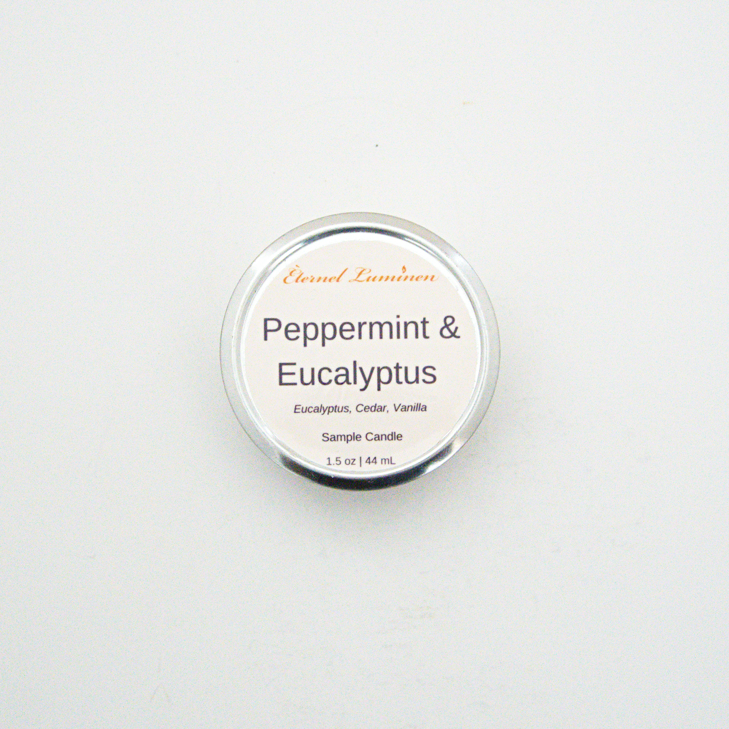 A 1.5oz Peppermint & Eucalyptus sample candle in a tin jar sitting against a white background made by Eternel Luminen
