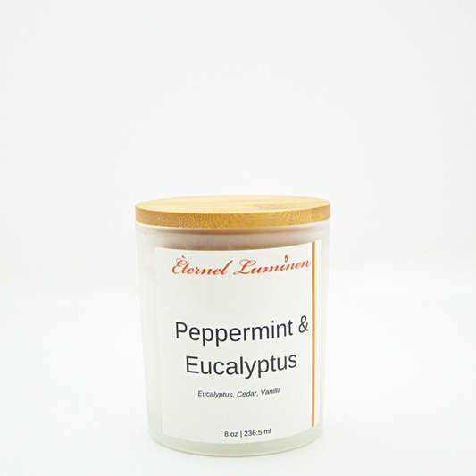 A 8 oz peppermint and eucalyptus frosted candle with a wooden lid sitting against a white background made by Eternel Luminen.