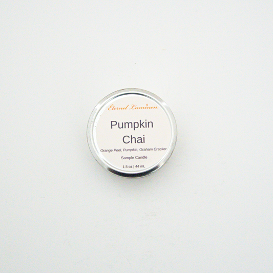 A 1.5oz Pumpkin Chai sample candle in a tin jar sitting against a white background made by Eternel Luminen