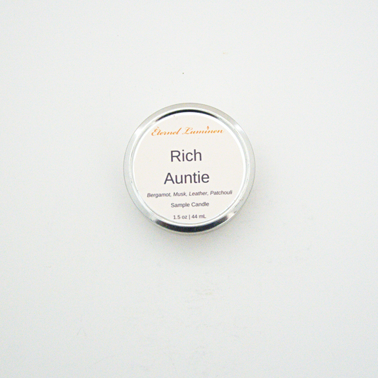 A 1.5oz Rich Auntie sample candle in a tin jar sitting against a white background made by Eternel Luminen