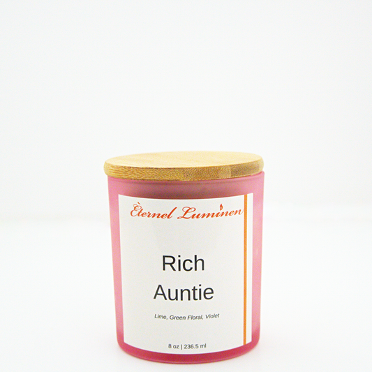 A 8 oz frosted Rich Auntie candle with a wooden lid sitting against a white background made by Eternel Luminen.
