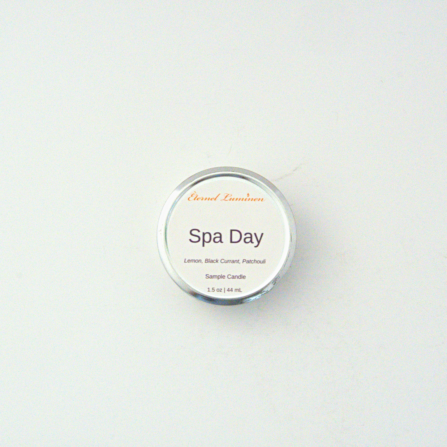 A 1.5oz Spa Day sample candle in a tin jar sitting against a white background made by Eternel Luminen