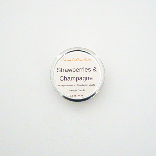 A 1.5oz Strawberries & Champagne sample candle in a tin jar sitting against a white background made by Eternel Luminen