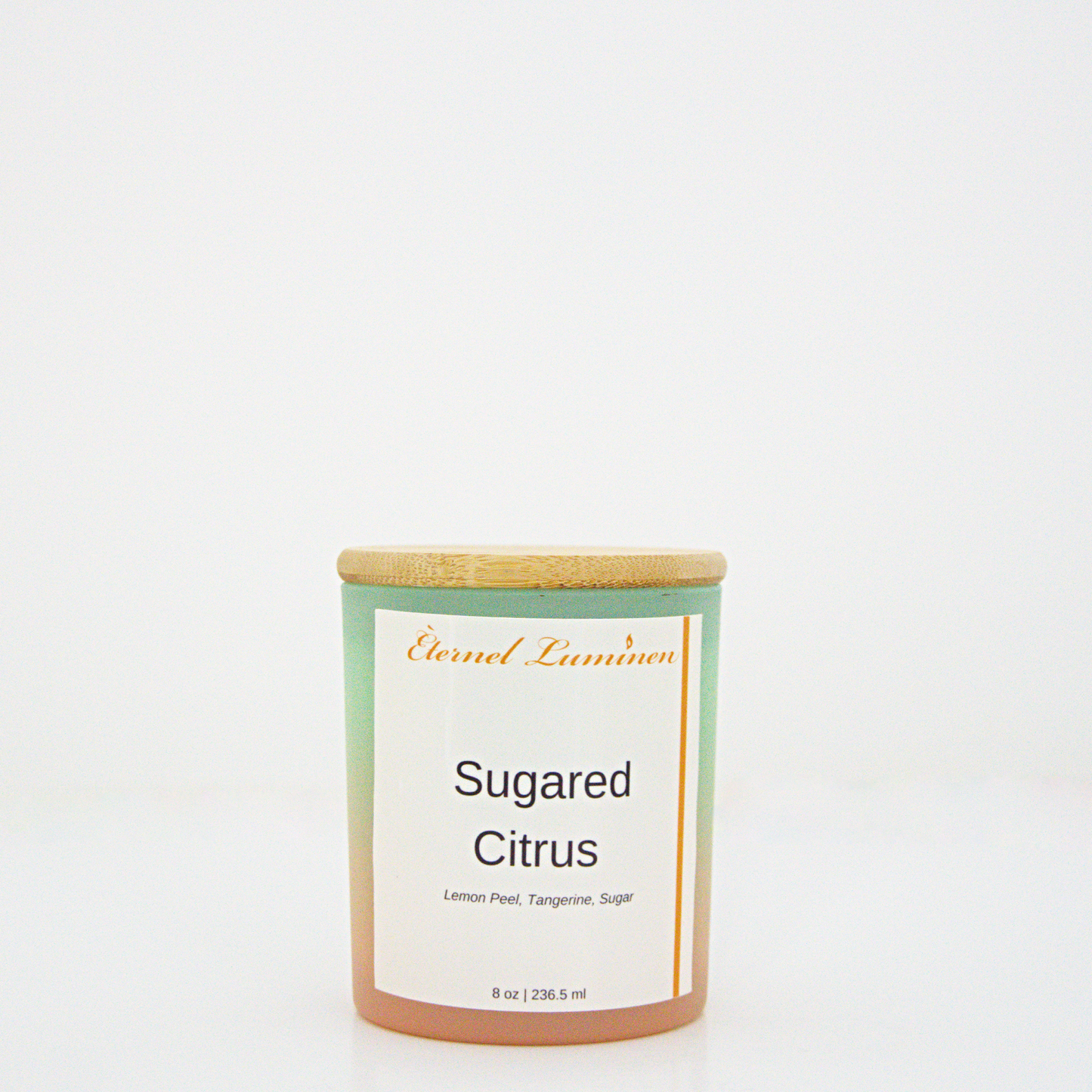 A 8 oz Sugared citrus frosted candle with a wooden lid sitting against a white background made by Eternel Luminen.