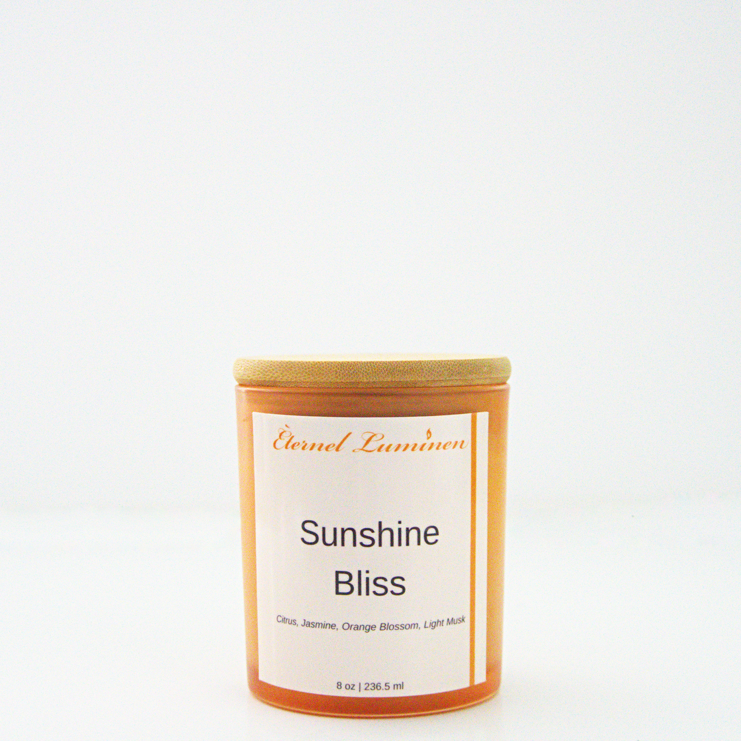 A 8 oz frosted Sunshine Bliss candle with a wooden lid sitting against a white background made by Eternel Luminen.