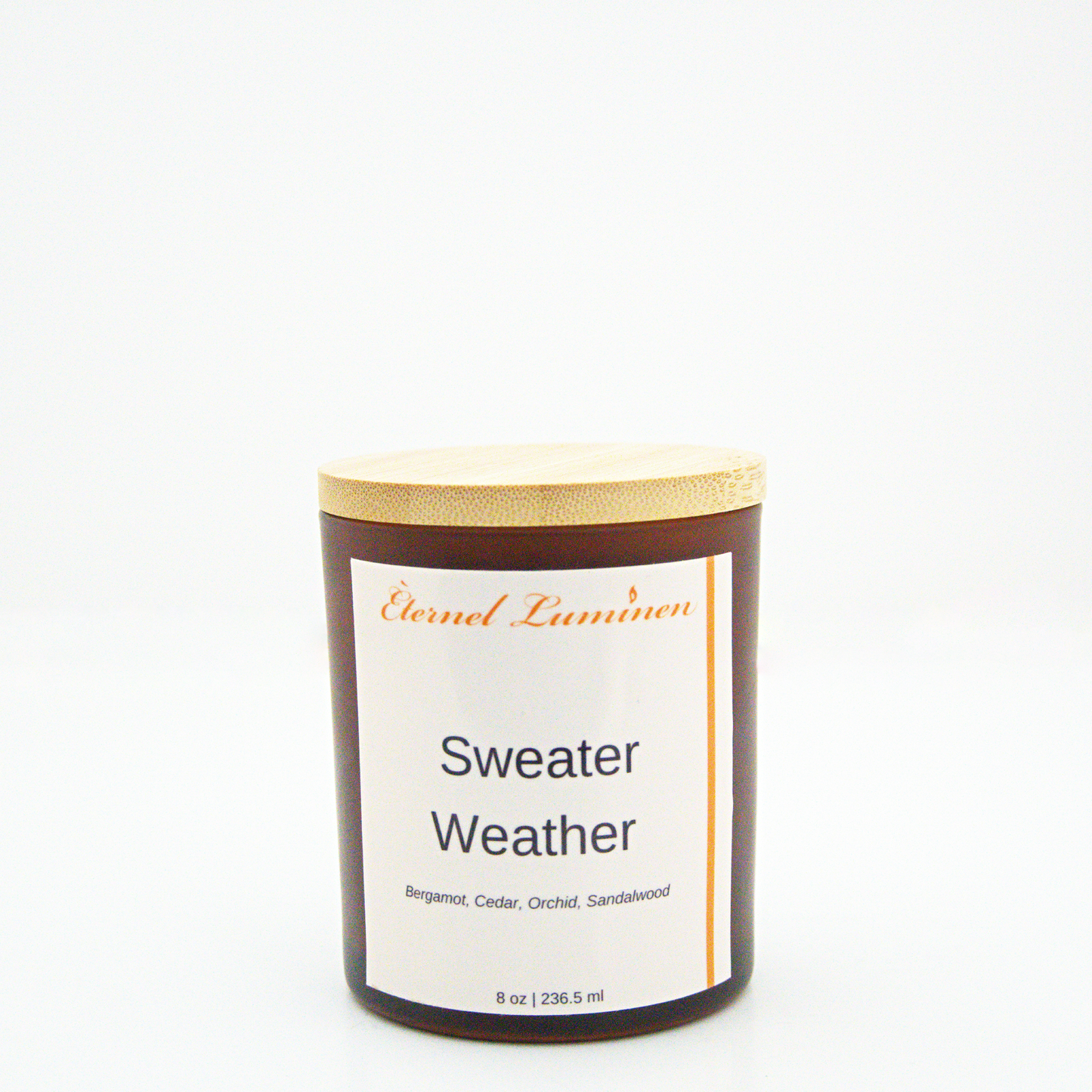A 8 oz frosted Sweater Weather candle with a wooden lid sitting against a white background made by Eternel Luminen.