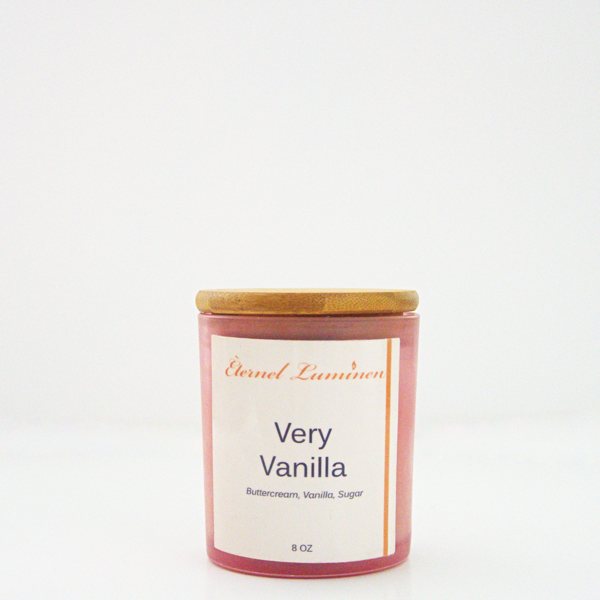 A 8 oz frosted Very Vanilla candle with a wooden lid sitting against a white background made by Eternel Luminen.