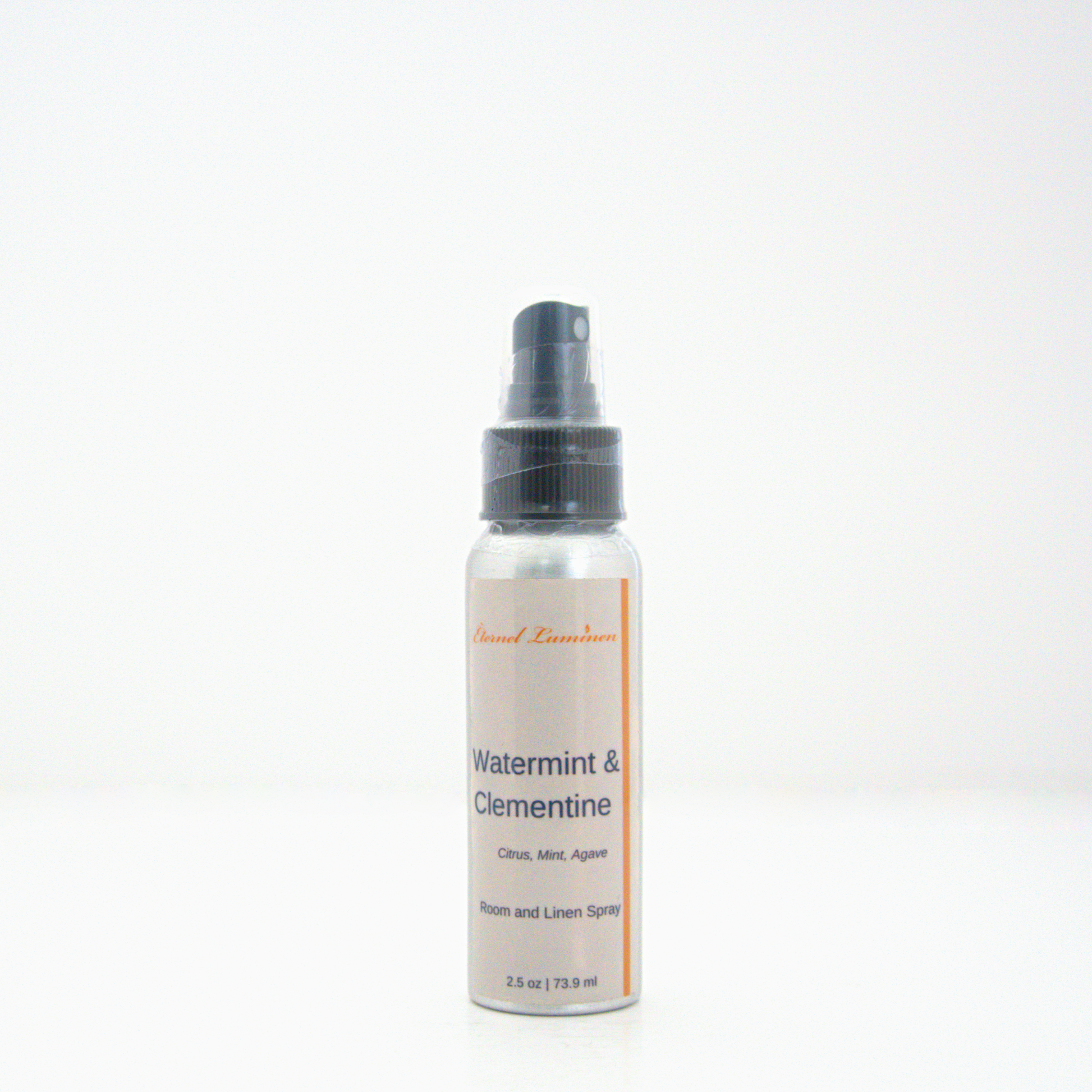 A 2.5oz Watermint & Clementine room & linen spray sitting against a white background made by Eternel Luminen.