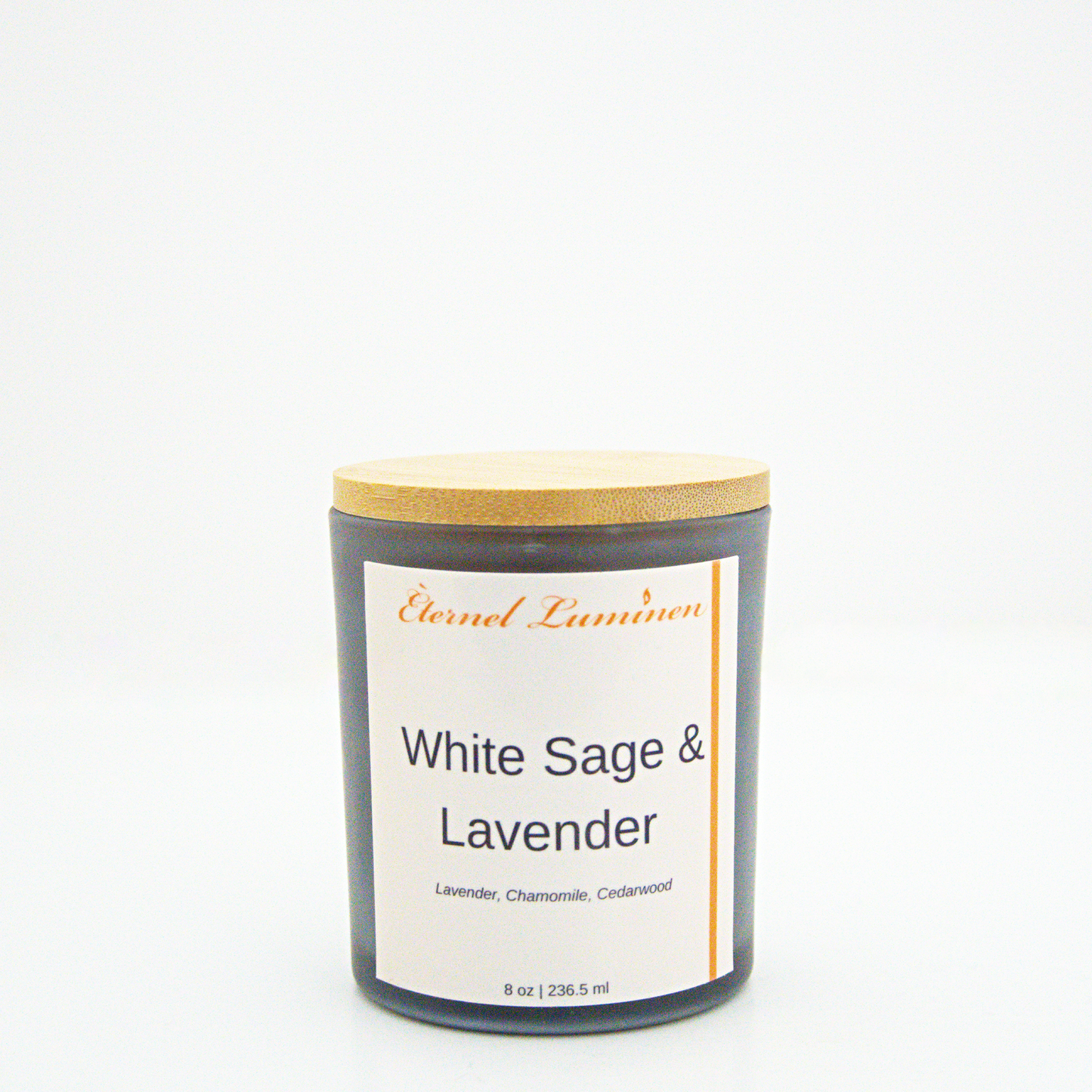 A 8 oz frosted White Sage & Lavender candle with a wooden lid sitting against a white background made by Eternel Luminen.