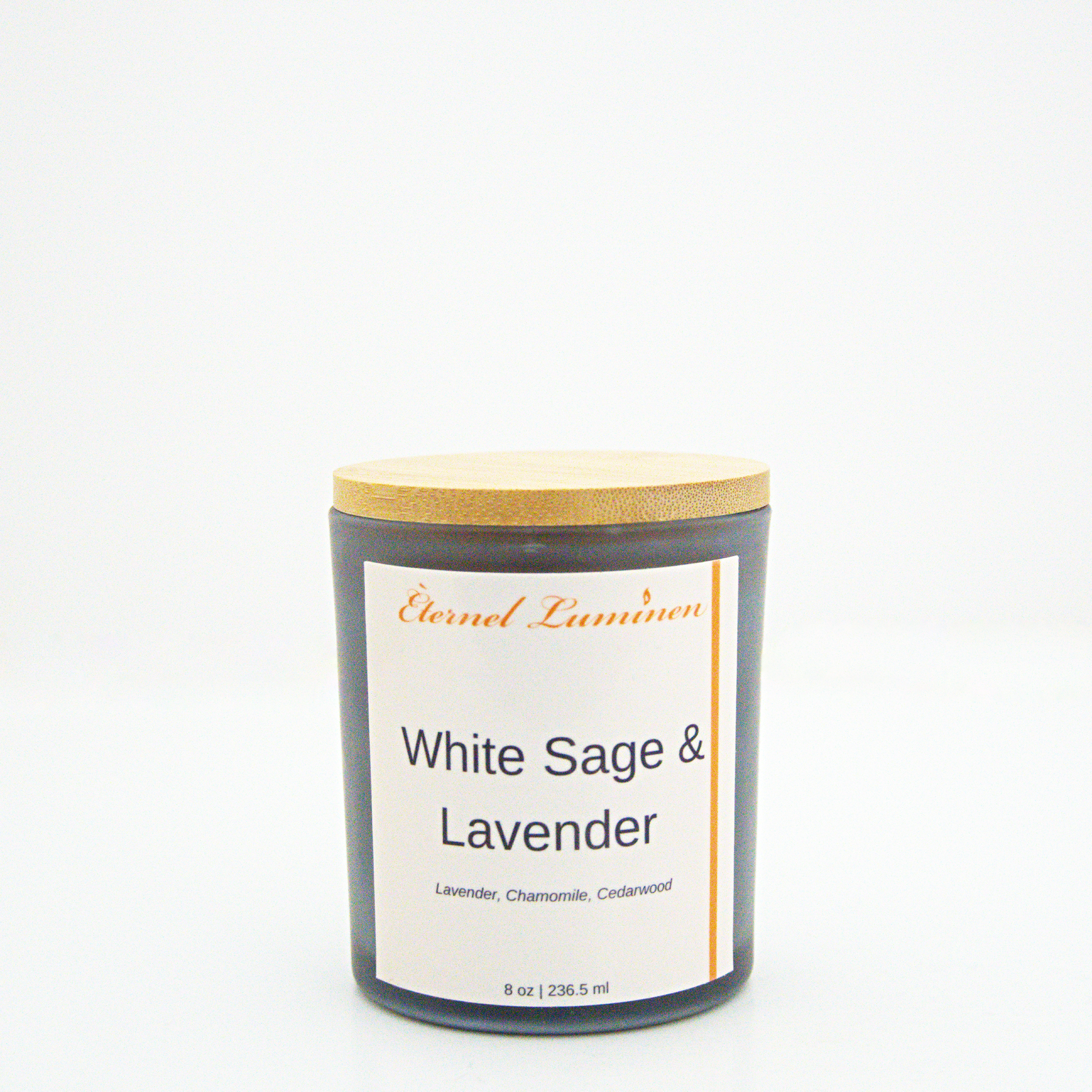 A 8 oz frosted White Sage & Lavender candle with a wooden lid sitting against a white background made by Eternel Luminen.