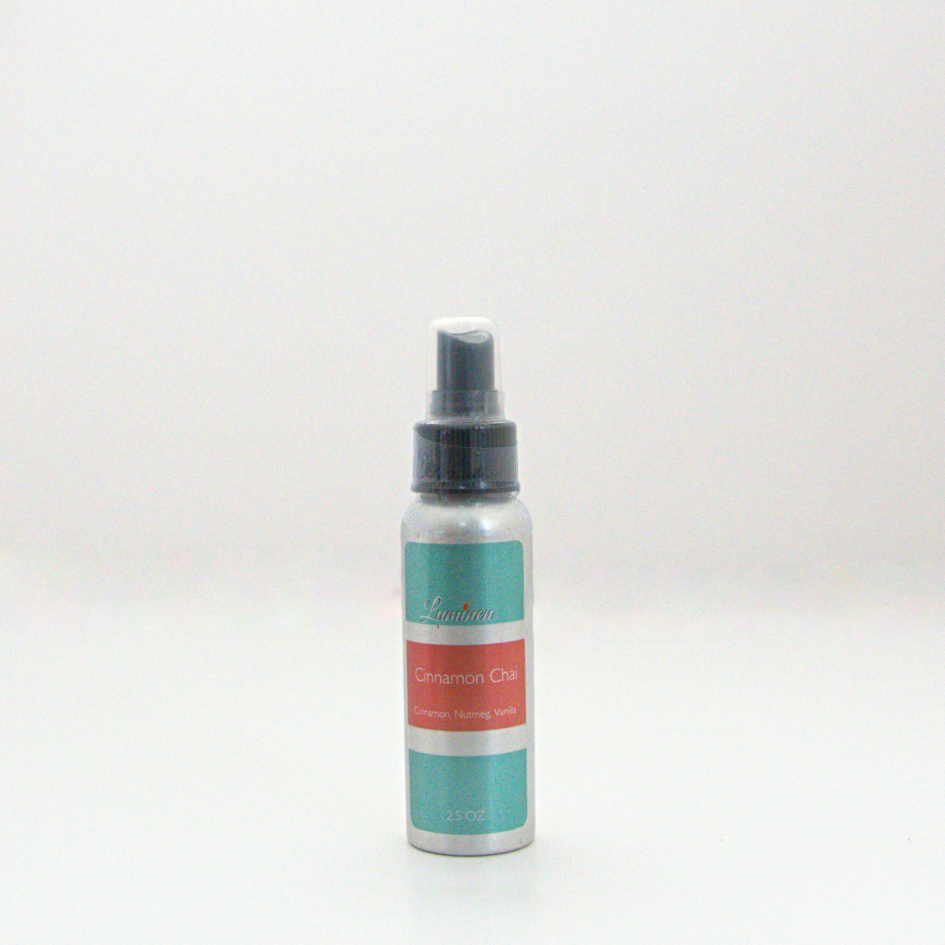 A 2.5oz Cinnamon Chai room & linen spray sitting against a white background made by Eternel Luminen.