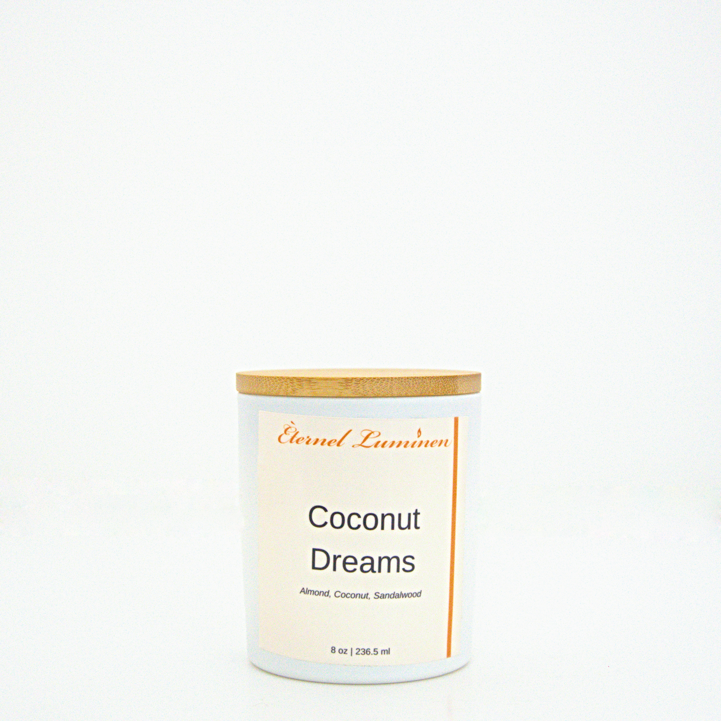 A 8 oz frosted Coconut Dreams candle with a wooden lid sitting against a white background made by Eternel Luminen.
