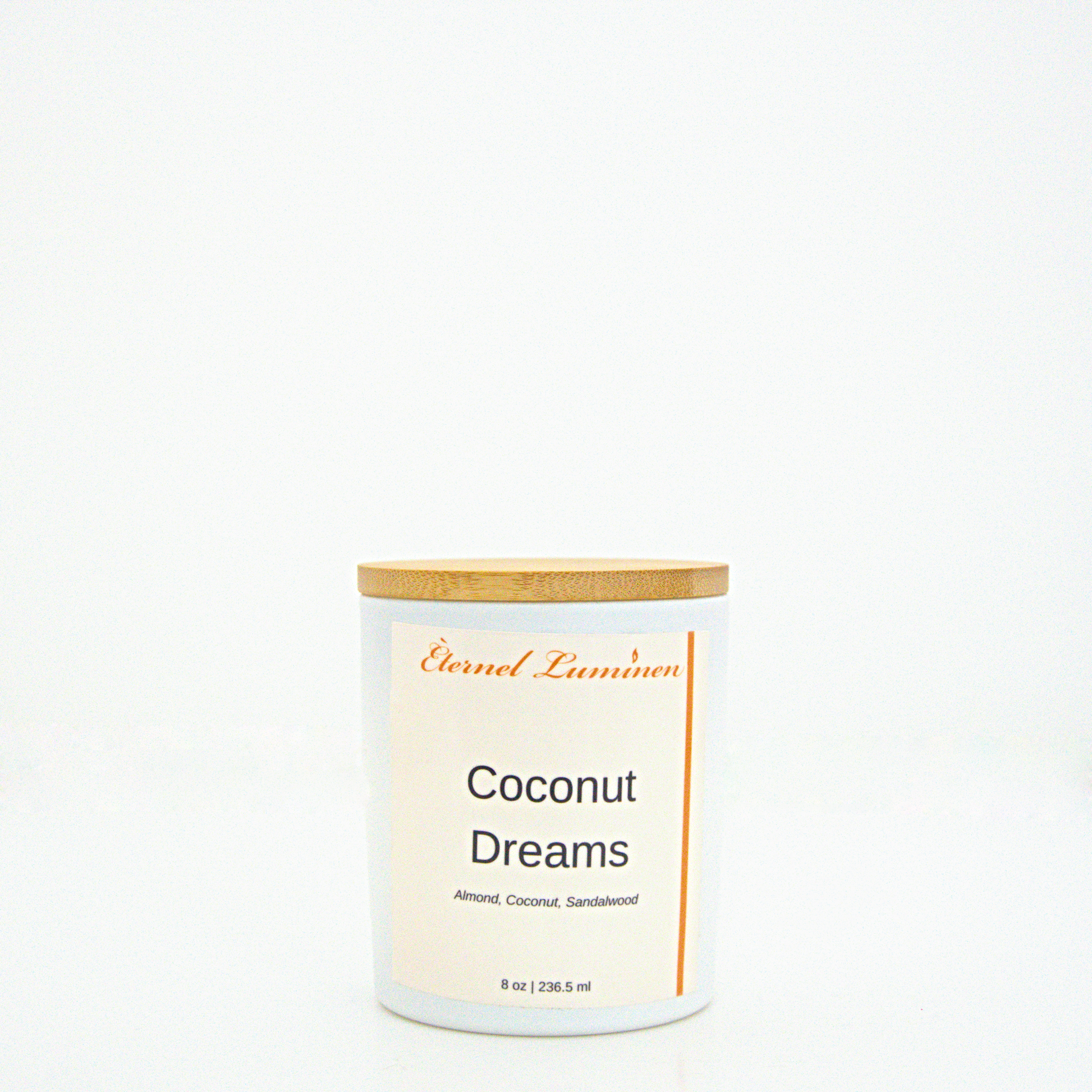 A 8 oz frosted Coconut Dreams candle with a wooden lid sitting against a white background made by Eternel Luminen.