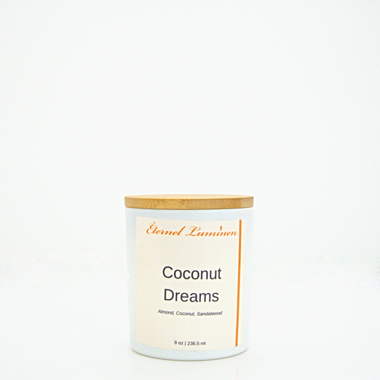 A 8 oz frosted Coconut Dreams candle with a wooden lid sitting against a white background made by Eternel Luminen.