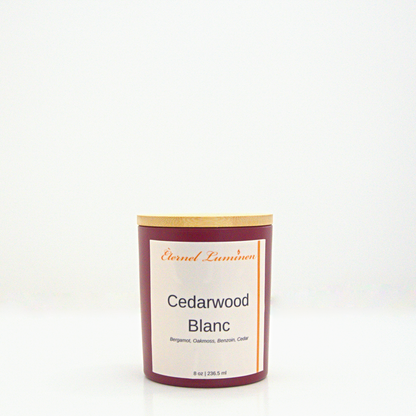 A 8oz frosted Cedarwood Blanc candle with a wooden lid sitting against a white background