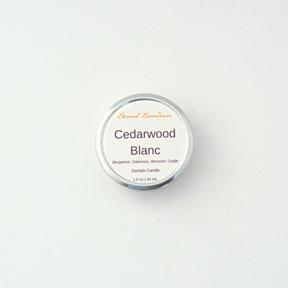 A 1.5oz Cedarwood Blanc sample candle in a tin jar sitting against a white background made by Eternel Luminen
