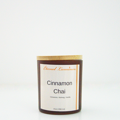 A 8 oz frosted Cinnamon Chai candle with a wooden lid sitting against a white background