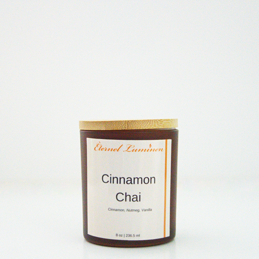 A 8 oz frosted Cinnamon Chai candle with a wooden lid sitting against a white background