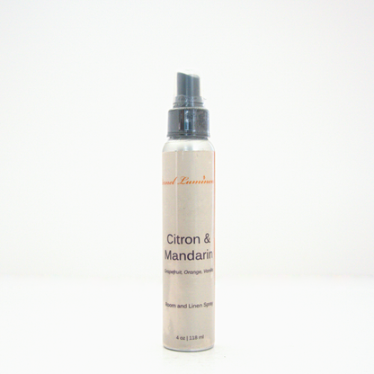 A 4oz Citron & Mandarin room & linen spray sitting against a white background made by Eternel Luminen.