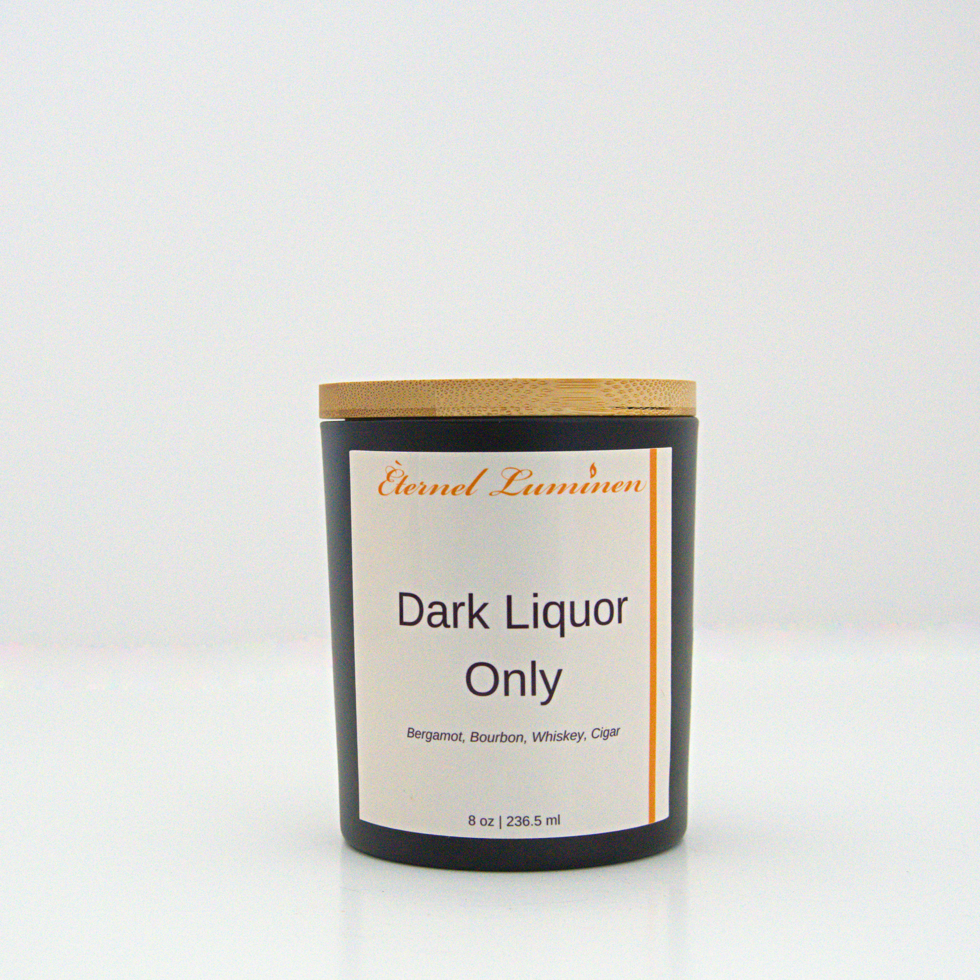 A 8 oz frosted Dark Liquor Only candle with a wooden lid sitting against a white background made by Eternel Luminen.