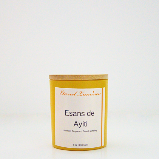 A 8 oz frosted Esans de Ayiti candle with a wooden lid sitting against a white background made by Eternel Luminen.