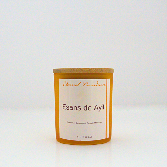 A 8 oz frosted Esans de Ayiti candle with a wooden lid sitting against a white background made by Eternel Luminen.