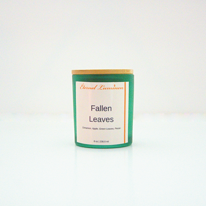 A 8 oz frosted Fallen Leaves candle with a wooden lid sitting against a white background made by Eternel Luminen.