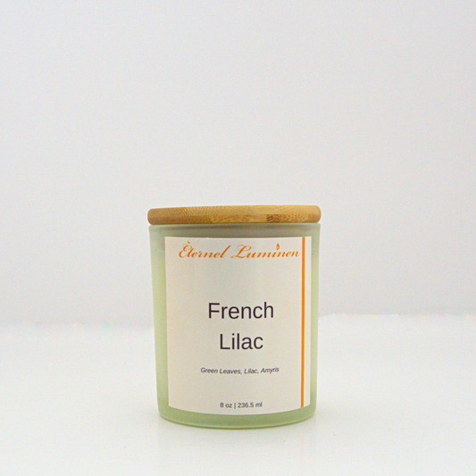 A 8 oz French lilac frosted candle with a wooden lid sitting against a white background made by Eternel Luminen.