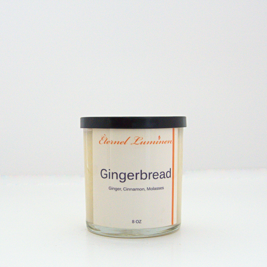 A 8 oz Gingerbread frosted candle with a wooden lid sitting against a white background made by Eternel Luminen.