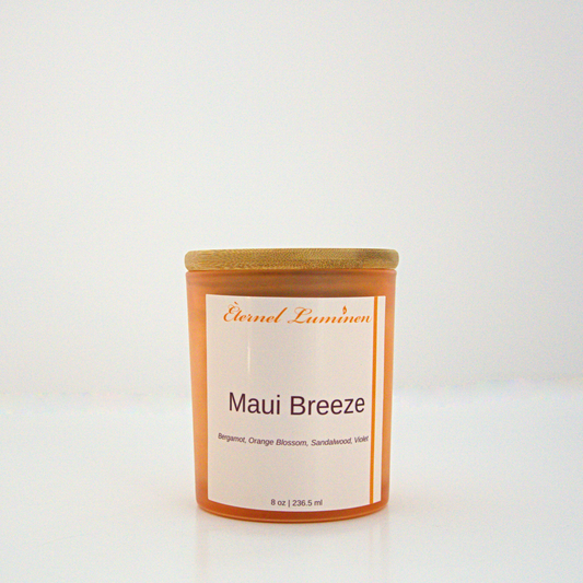 A 8 oz frosted Maui Breeze candle with a wooden lid sitting against a white background made by Eternel Luminen.