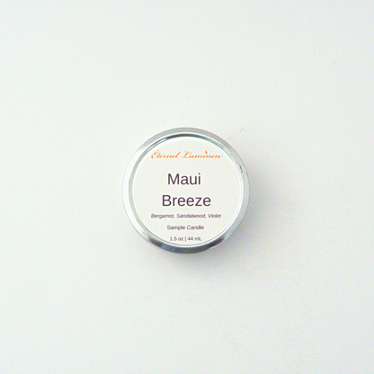 A 1.5oz Maui Breeze  sample candle in a tin jar sitting against a white background made by Eternel Luminen