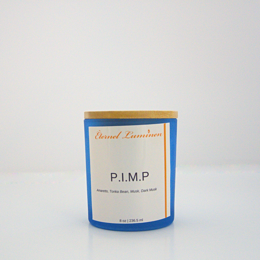 A 8 oz P.I.M.P frosted candle with a wooden lid sitting against a white background made by Eternel Luminen.