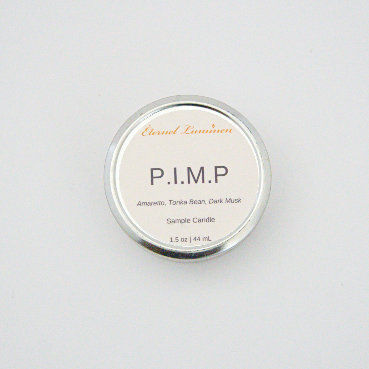 A 1.5oz P.I.M.P sample candle in a tin jar sitting against a white background 