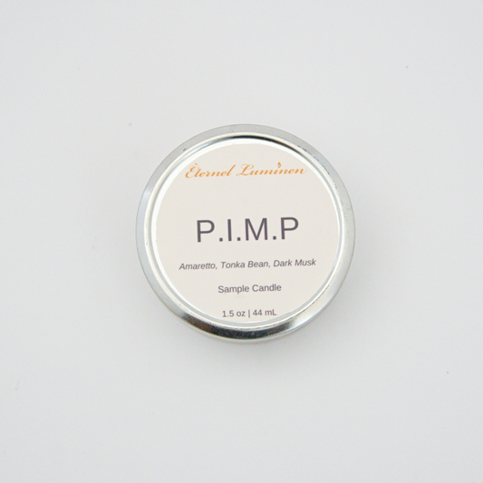 A 1.5oz P.I.M.P sample candle in a tin jar sitting against a white background 